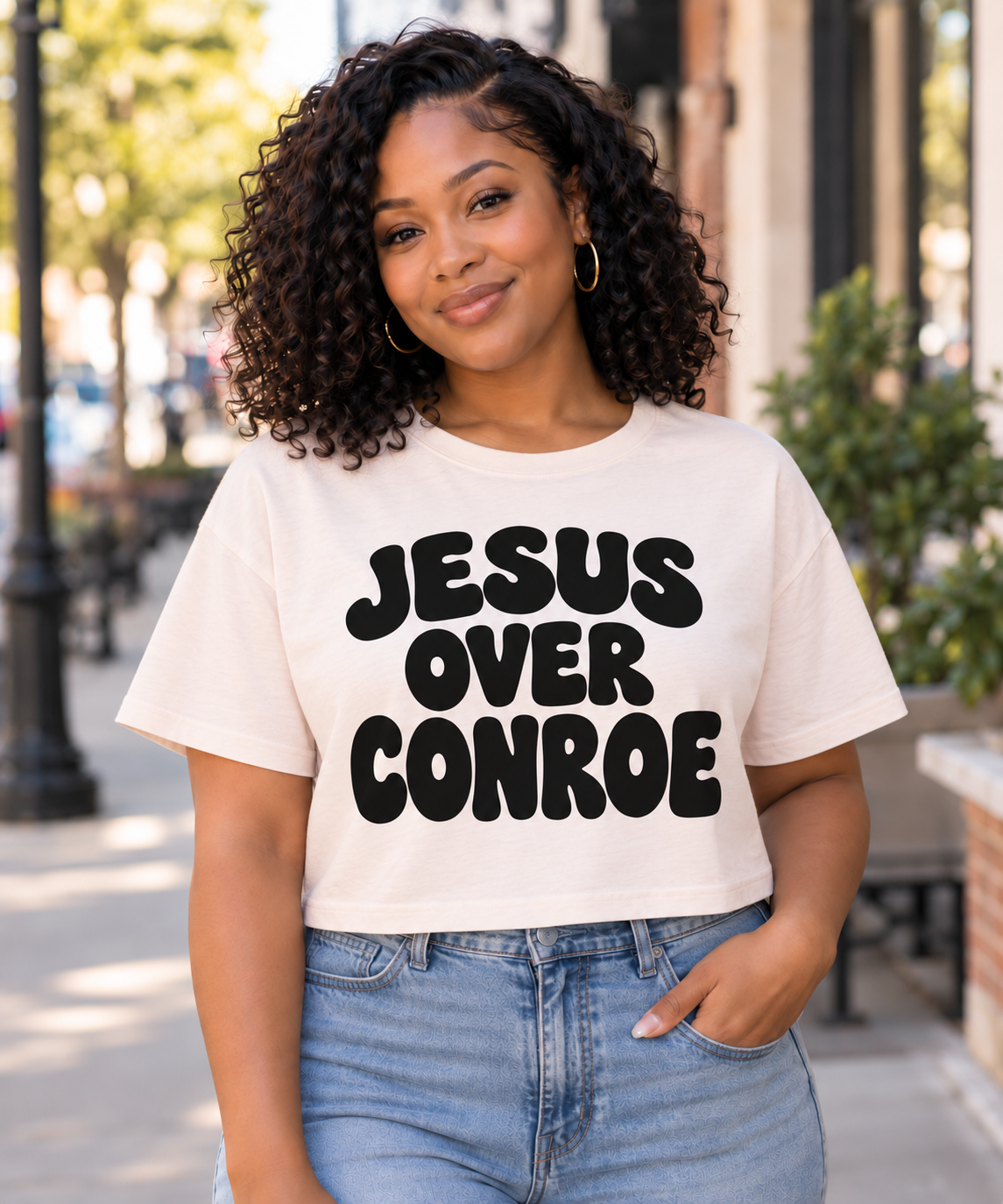 JESUS OVER CONROE rounded lettering on ivory boxy crop tee
