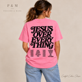 Woman from behind in Rose Quartz Comfort Colors tee with smooth JESUS OVER EVERYTHING lettering and four text columns